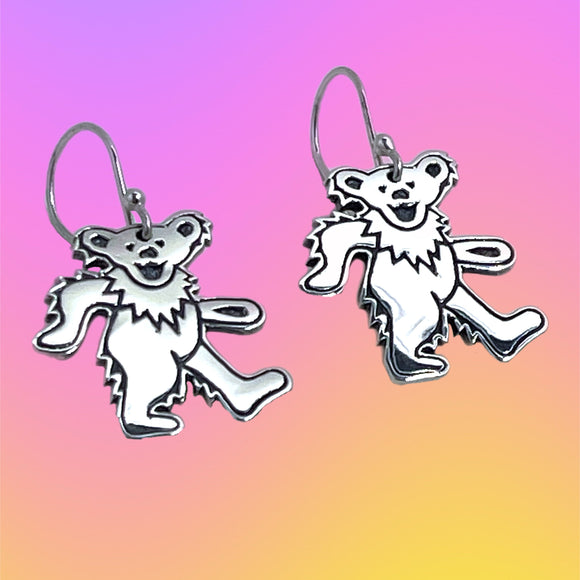 Dancing bear earrings on a gradient background