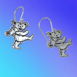 Silver dancing bear earrings on a gradient blue background