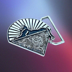 Decorative belt buckle with intricate patterns on a gradient background